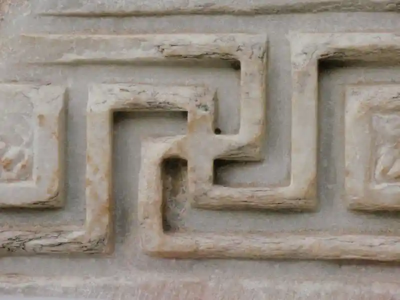 Swastika with long arms on a marble stone